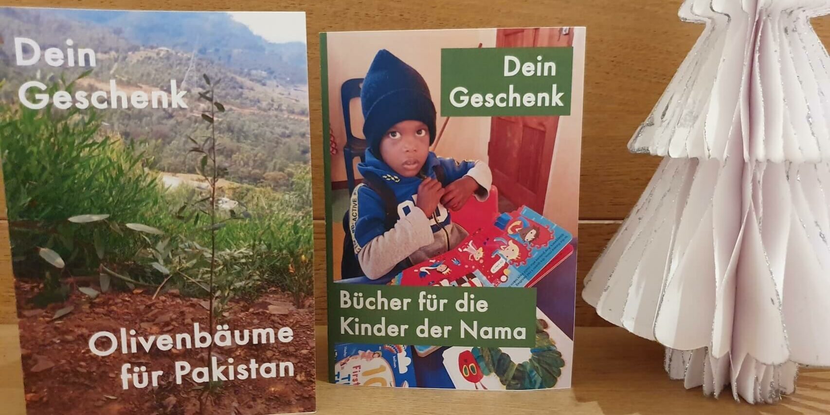 2023_speendengeschenke_1 Wir bieten in unseren beiden Weltläden in Hofheim für unsere neuen Projekte Spendengeschenke an: "Bücher für die Kinder der Nama" und "Olivenbäume für Pakistan".